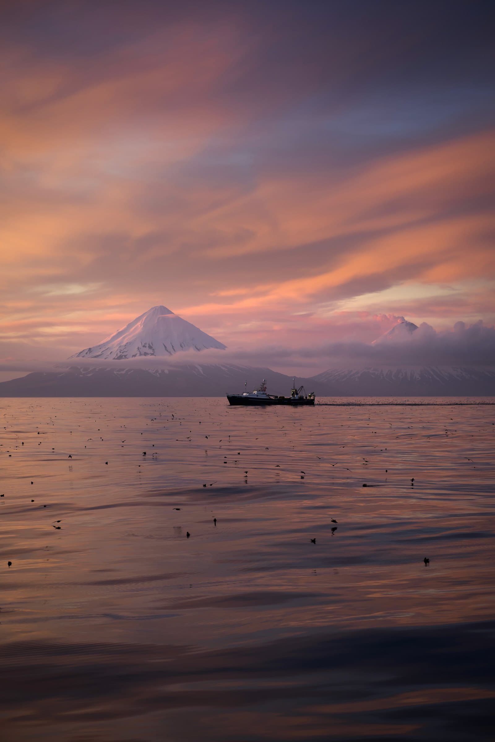 Fishing vessel at sunset off the Alaskan coast